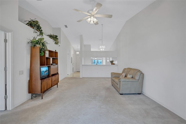 sitting room with high vaulted ceiling, ceiling fan with notable chandelier, and light colored carpet