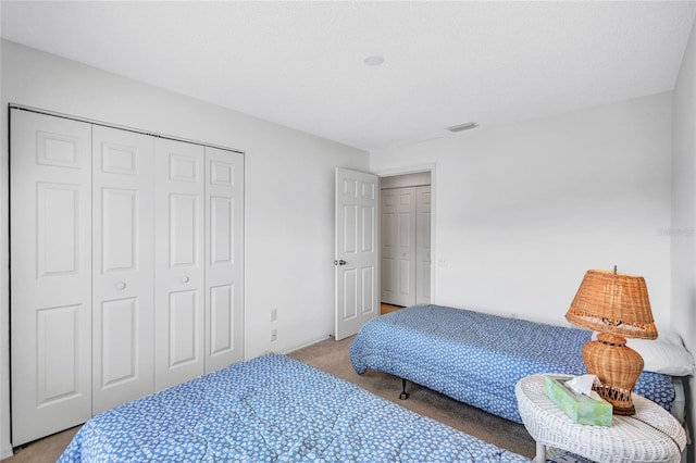 carpeted bedroom with a closet