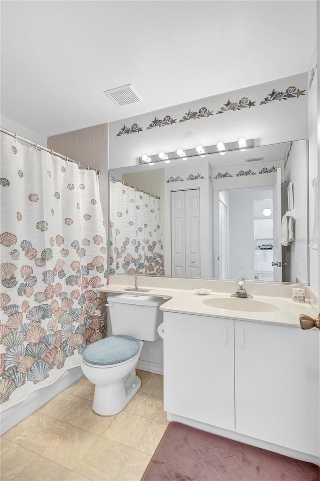 bathroom featuring vanity, a shower with shower curtain, and toilet