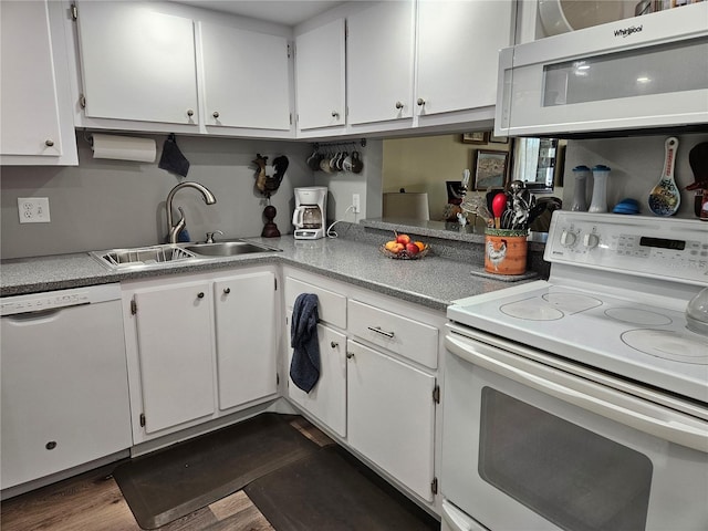 kitchen featuring dark wood-style floors, white appliances, white cabinetry, and a sink