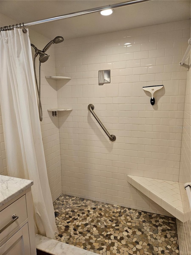 bathroom with a stall shower and vanity