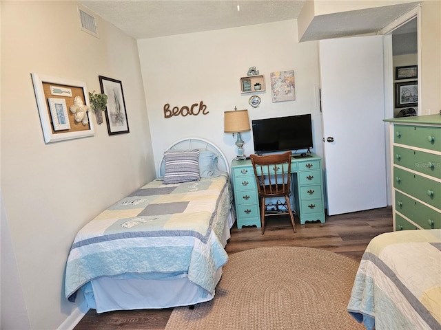 bedroom with visible vents and wood finished floors