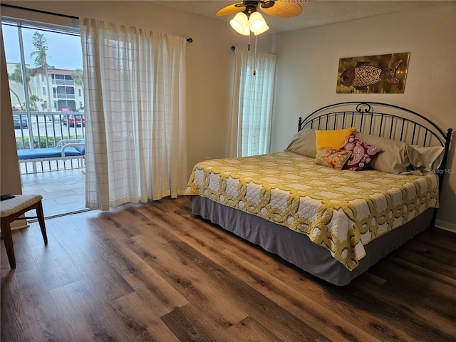 bedroom with access to outside, wood finished floors, and a ceiling fan