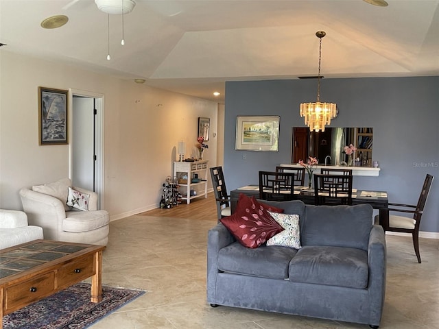 living room featuring vaulted ceiling and ceiling fan with notable chandelier