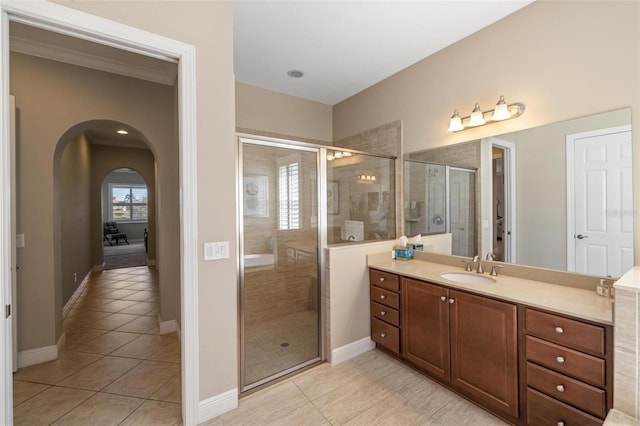 bathroom with tile patterned flooring, vanity, and an enclosed shower