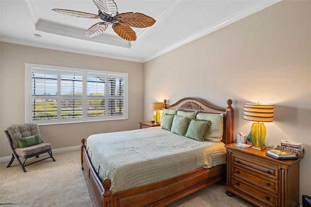 carpeted bedroom featuring crown molding, ceiling fan, and a tray ceiling