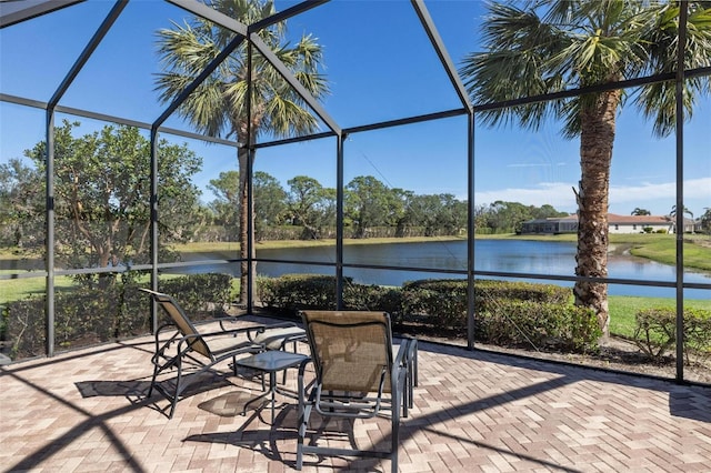 unfurnished sunroom featuring a water view