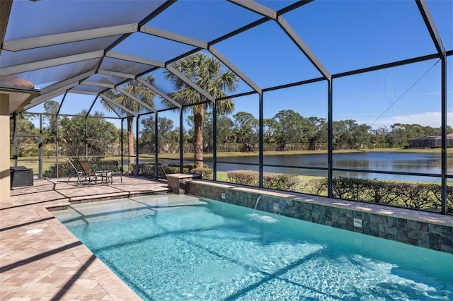 view of pool featuring a patio, pool water feature, a water view, and glass enclosure