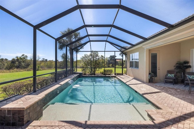 view of pool featuring pool water feature, a patio area, and glass enclosure