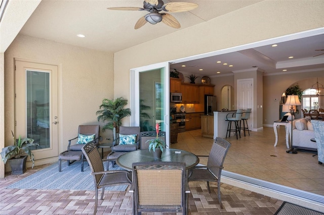 view of patio / terrace with ceiling fan and exterior bar