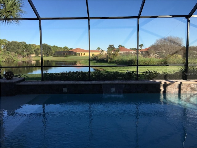 view of swimming pool featuring a water view and glass enclosure