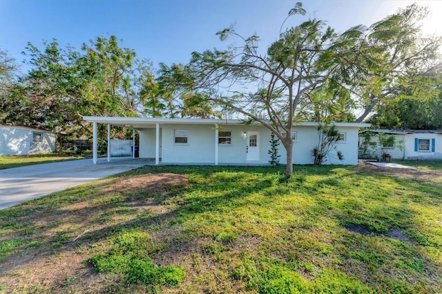 ranch-style home with a front yard and a carport