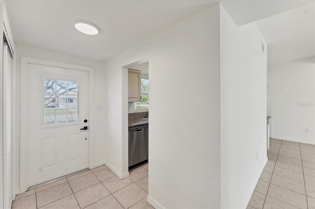 entryway featuring light tile patterned floors and plenty of natural light