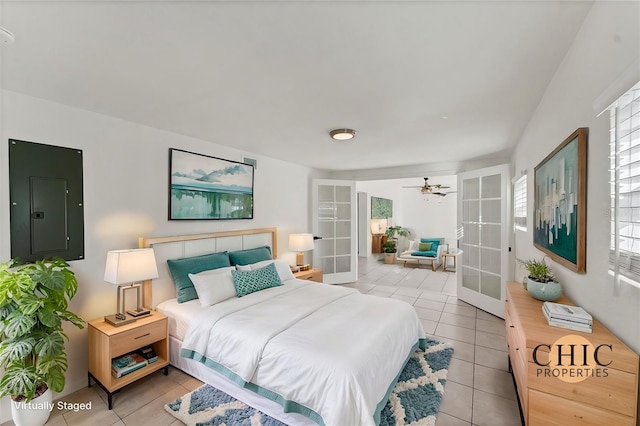 tiled bedroom featuring electric panel and french doors