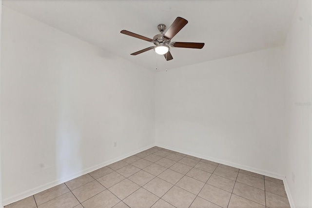 empty room with ceiling fan and light tile patterned flooring