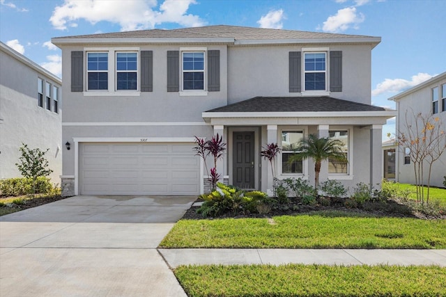 view of front property with a garage and a front lawn