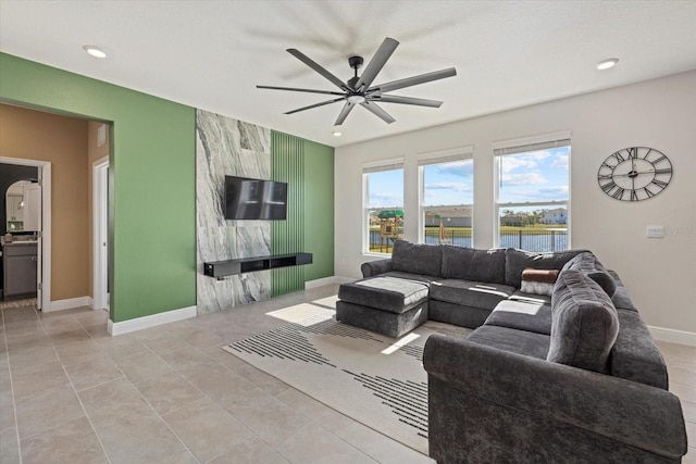 tiled living room with ceiling fan