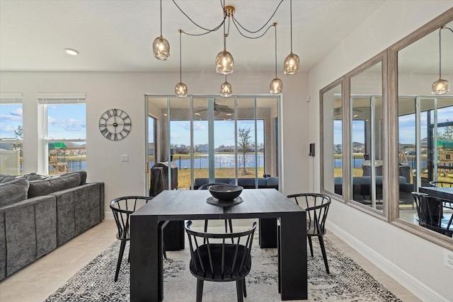 tiled dining area with a water view