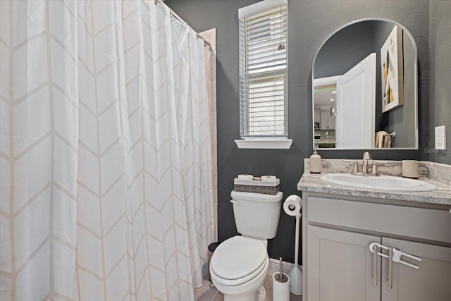 bathroom featuring vanity, toilet, and a shower with shower curtain