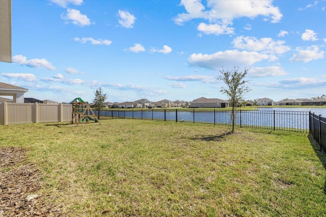 view of yard with a playground and a water view