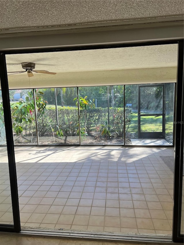 interior space with ceiling fan