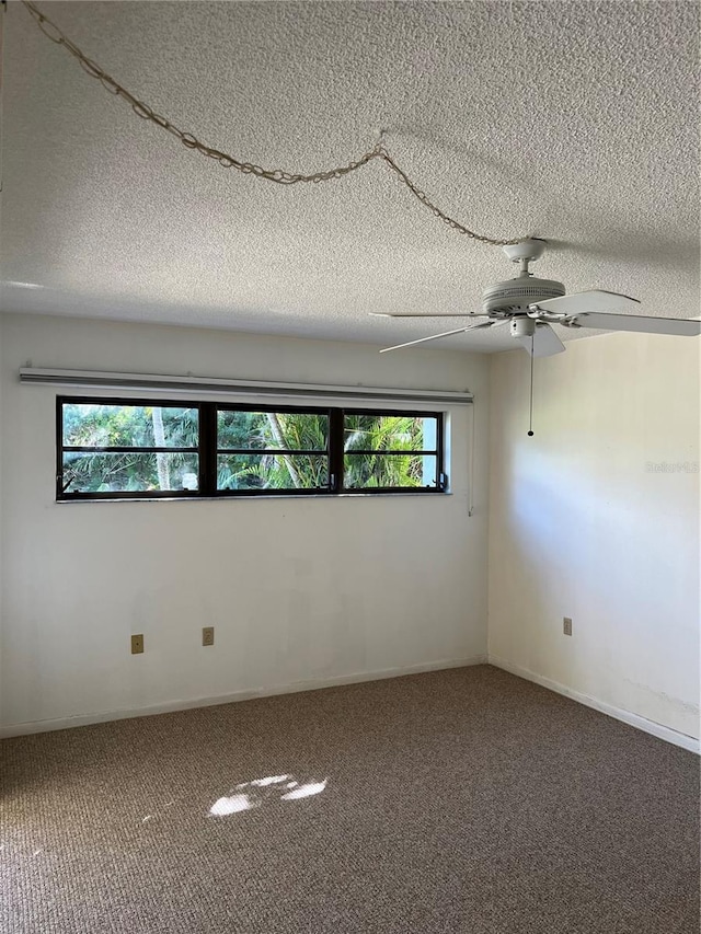 unfurnished room featuring carpet, plenty of natural light, and a textured ceiling