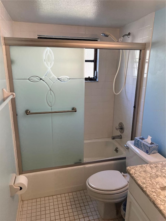 full bathroom featuring toilet, combined bath / shower with glass door, a textured ceiling, vanity, and tile patterned flooring