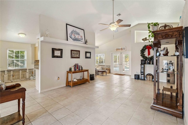 exercise area with high vaulted ceiling, light tile patterned floors, ceiling fan, and french doors