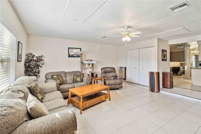 living room featuring light tile patterned flooring and ceiling fan