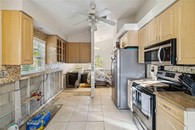 kitchen with light brown cabinetry, tasteful backsplash, and stainless steel appliances