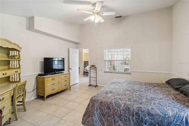 bedroom featuring lofted ceiling, light tile patterned floors, and ceiling fan