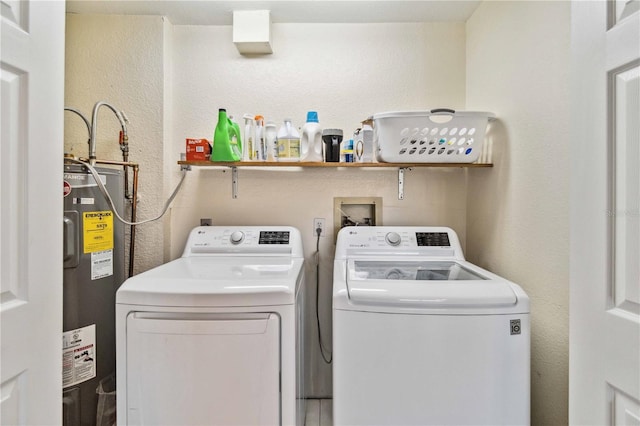 washroom with electric water heater and washer and dryer