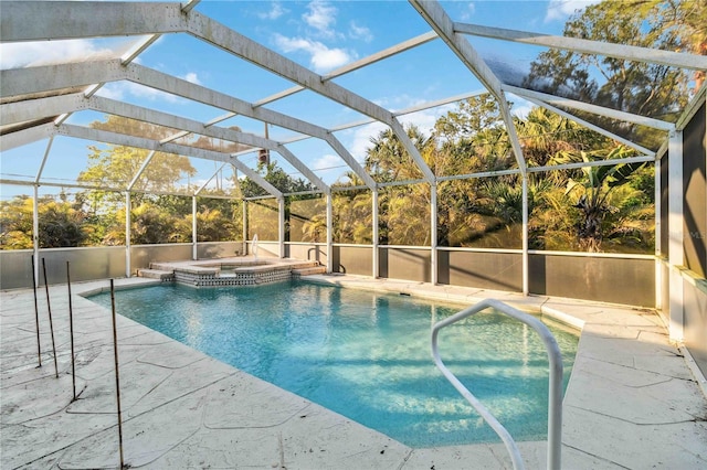 view of pool with an in ground hot tub, a patio, and glass enclosure