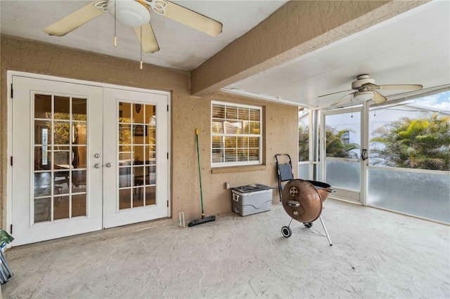 sunroom featuring french doors and ceiling fan