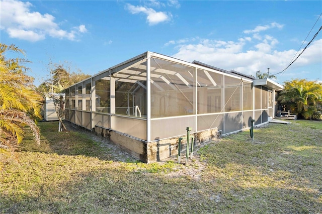 exterior space featuring glass enclosure and a lawn