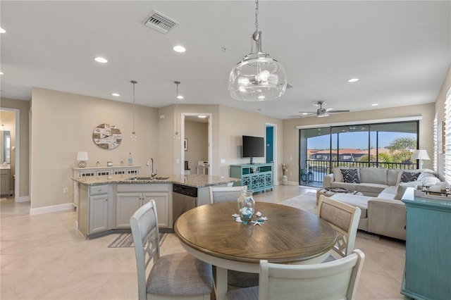 tiled dining area featuring sink and ceiling fan