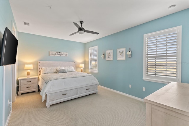 bedroom with light colored carpet and ceiling fan