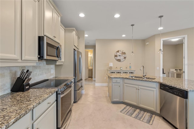 kitchen with appliances with stainless steel finishes, sink, backsplash, hanging light fixtures, and light stone counters