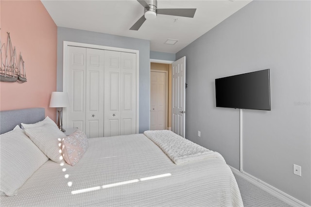 carpeted bedroom with ceiling fan and a closet