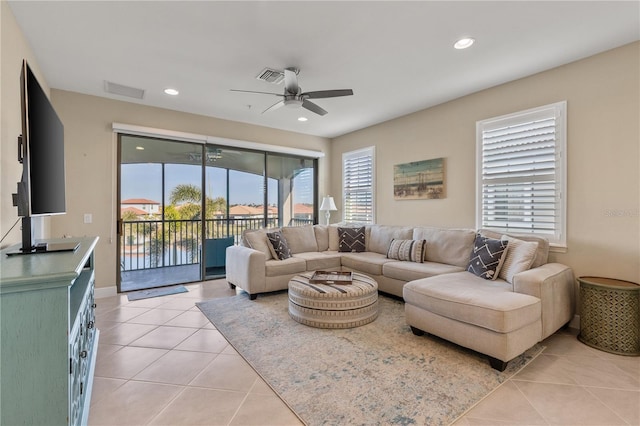 living room with light tile patterned flooring and ceiling fan