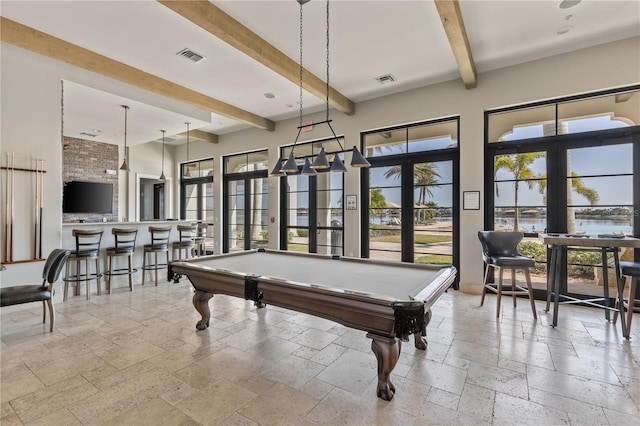 game room with french doors, pool table, bar, and beam ceiling