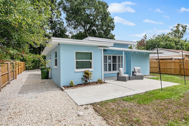 back of house featuring outdoor lounge area and a patio area