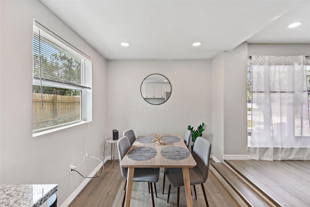 dining space with hardwood / wood-style flooring