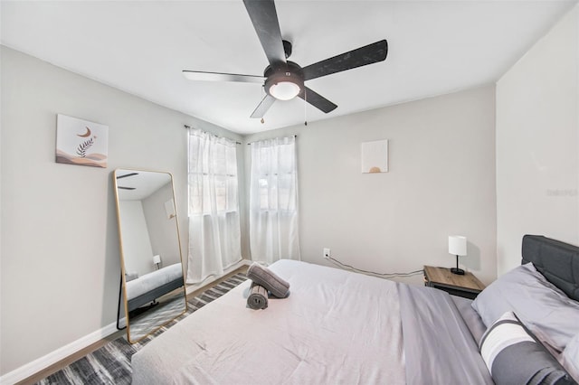 bedroom with wood-type flooring and ceiling fan