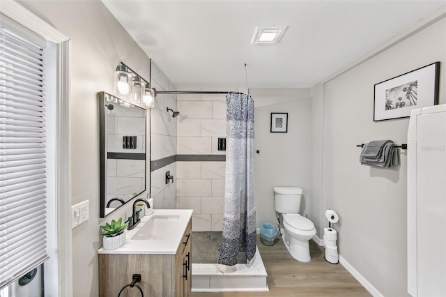 bathroom featuring toilet, hardwood / wood-style floors, vanity, and a shower with curtain