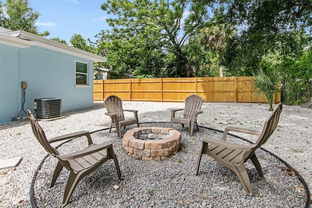 view of patio with central AC and an outdoor fire pit