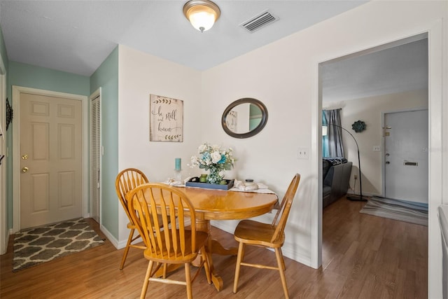 dining area with hardwood / wood-style flooring