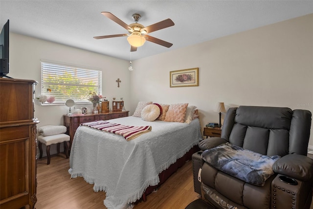 bedroom with ceiling fan and light wood-type flooring