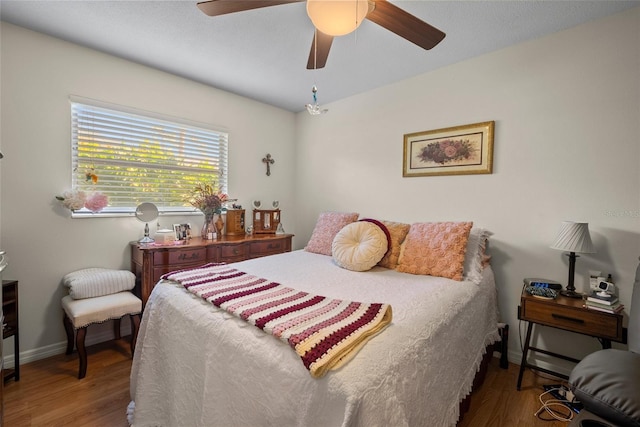 bedroom featuring hardwood / wood-style flooring and ceiling fan