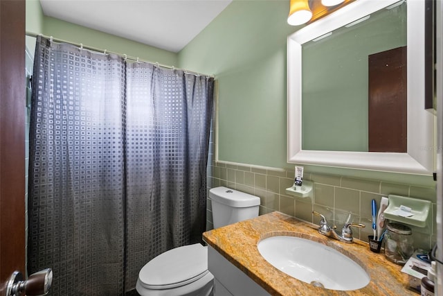 bathroom with tile walls, vanity, toilet, and walk in shower